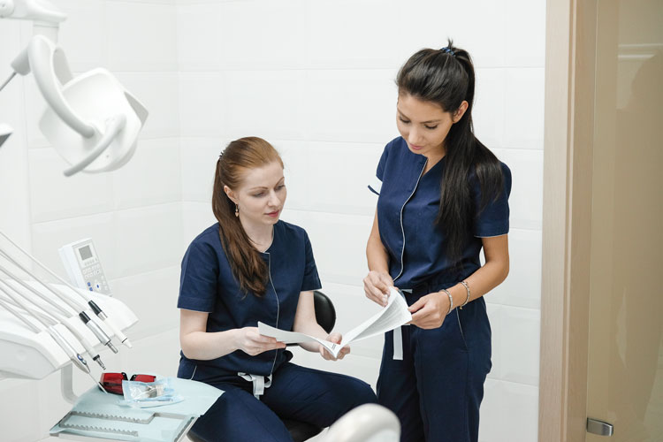 two hygienists review consulting instructions